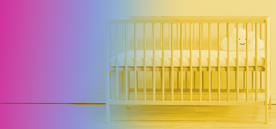 A crib with a gradient overlay of pink purple, blue, and yellow